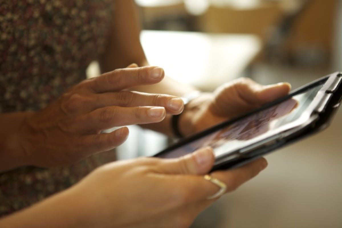 Two people using tablet for patient education.